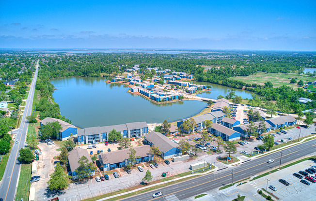 an aerial view of a city with a lake and a highway