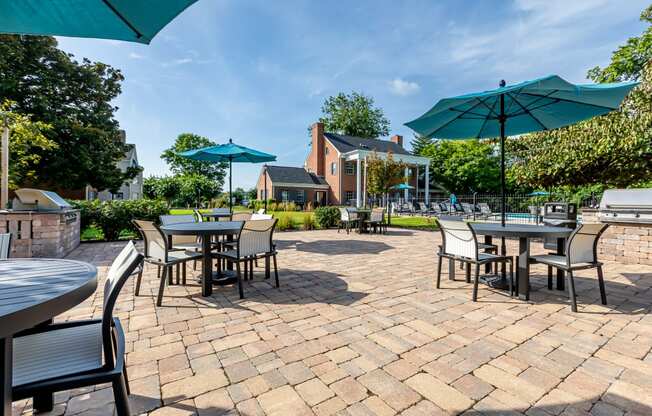 patio with dining tables and umbrellas