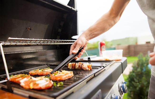 a man grilling food on a grill