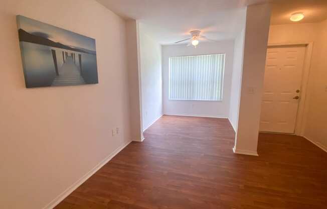 Spacious floor plan with hardwood style flooring and multi speed ceiling fan