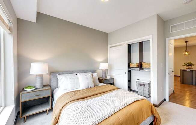 A bedroom with a large bed and a window.