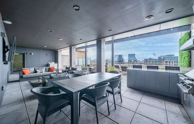 A modern outdoor dining area with a table and chairs.