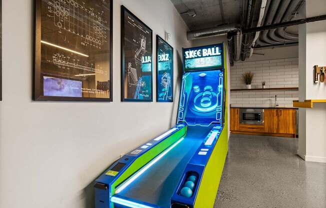 A Skee Ball arcade game is in the middle of a room.