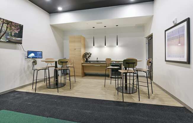 A room with a white wall and a black ceiling with a framed picture hanging on it.