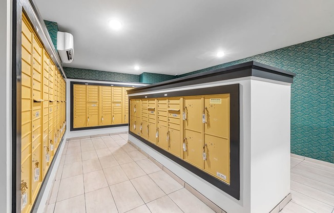 A hallway with a row of yellow lockers on the left and a row of yellow lockers on the right.