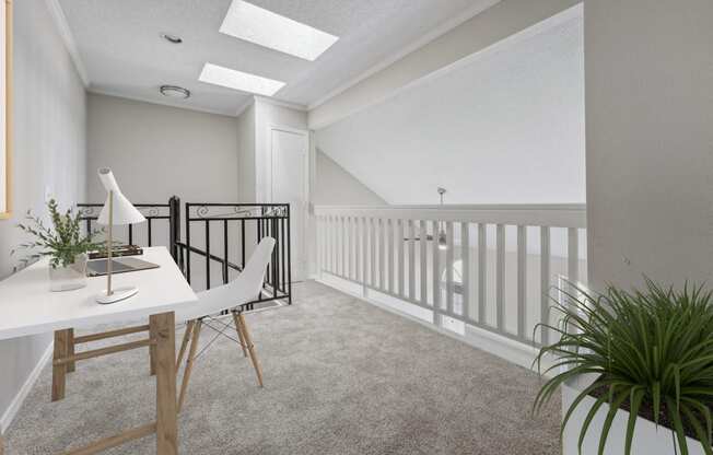 a home office with a white desk and a balcony