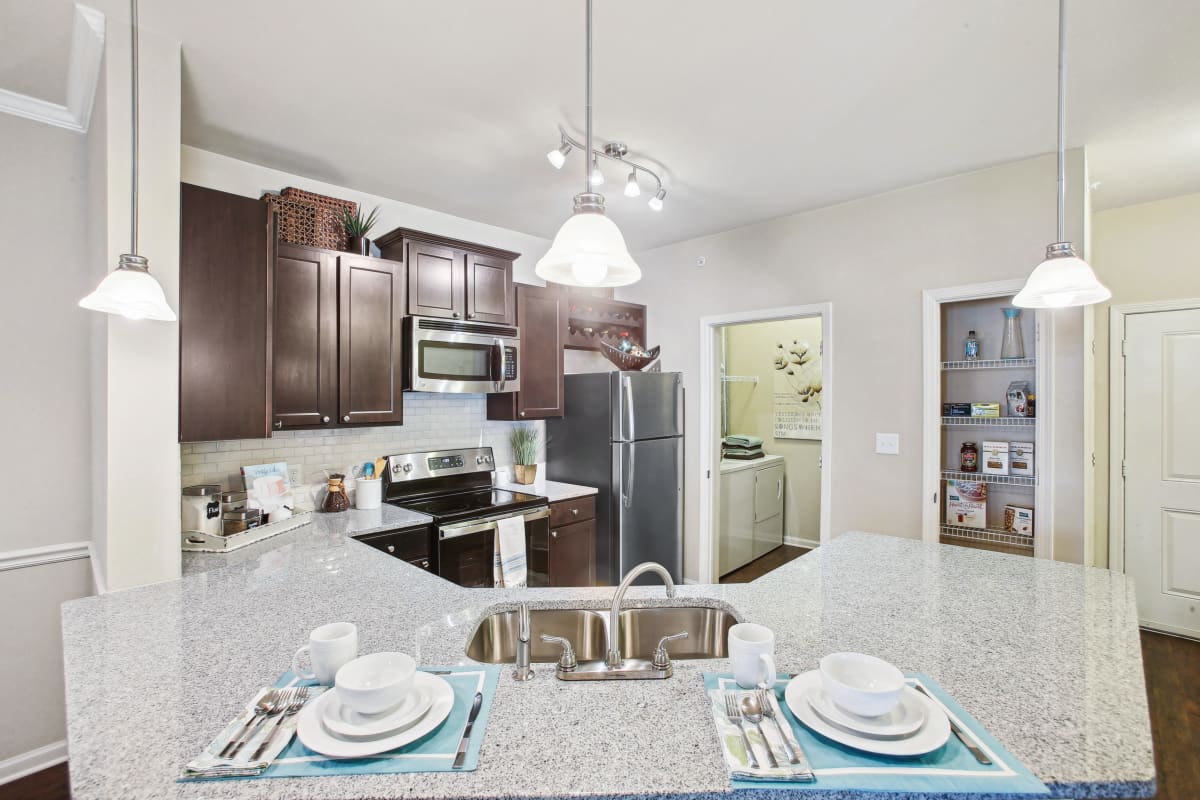 a kitchen with stainless steel appliances and granite counter tops