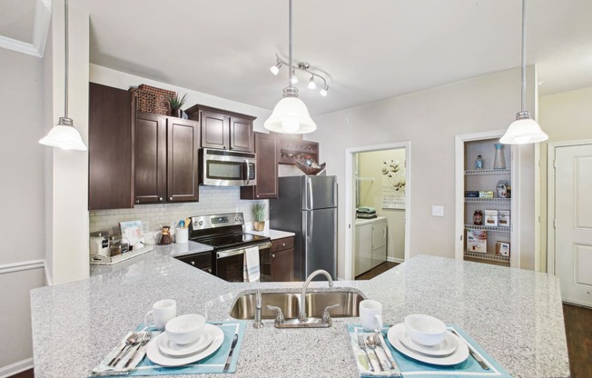 a kitchen with stainless steel appliances and granite counter tops