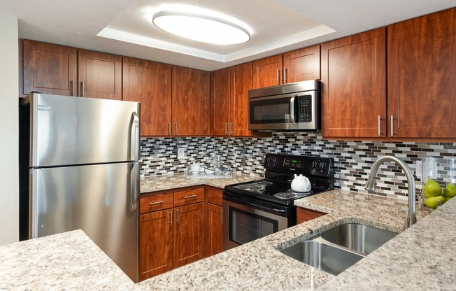 a kitchen with granite counter tops and stainless steel appliances