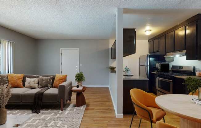 a living room and kitchen with a couch and a table