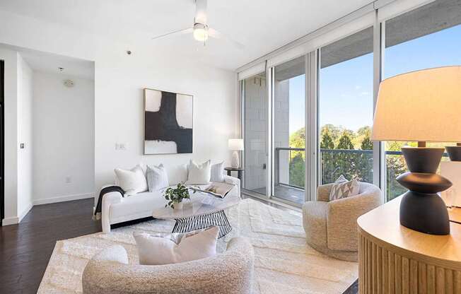 A living room with a white couch and a grey armchair.