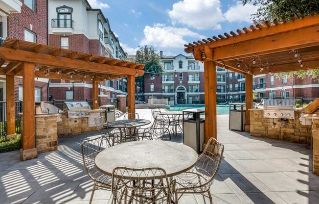 an outdoor patio with tables and chairs and a pool