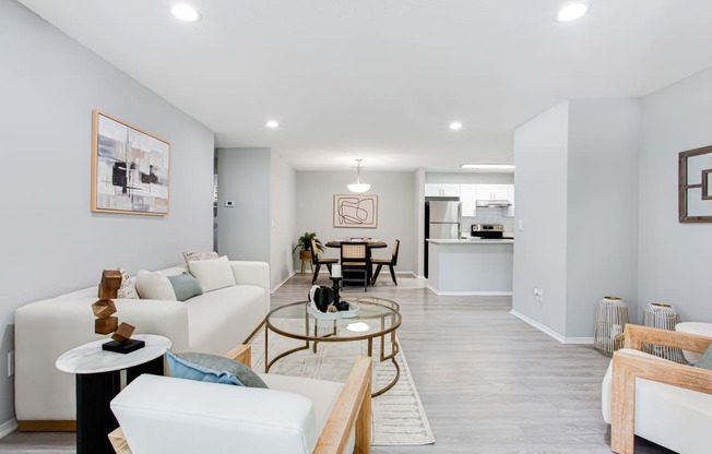 a living room with white couches and a table at Parc at 1875, College Park, Georgia