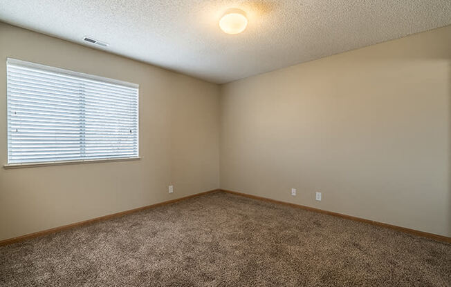 Large bedroom with bright lighting at Skyline View Apartments in Lincoln NE