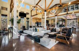 a large living room filled with furniture and chandeliers