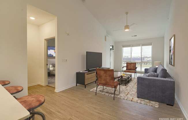 a living room with hardwood flooring and a flat screen tv