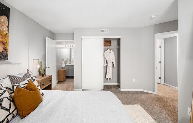 A bedroom with a large bed and a wardrobe.