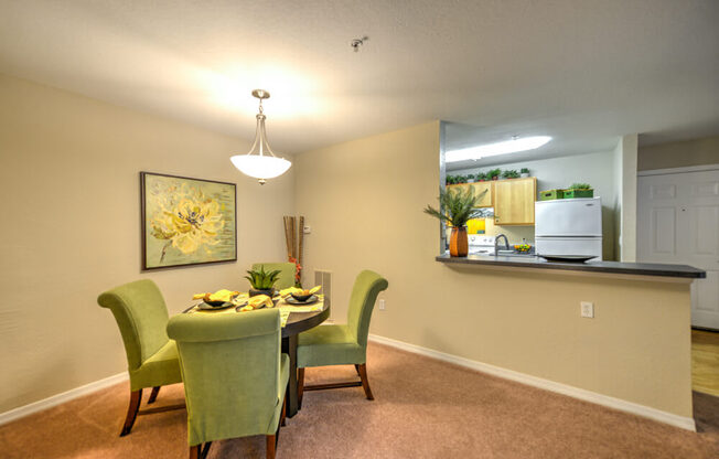A dining room with a table set for four.