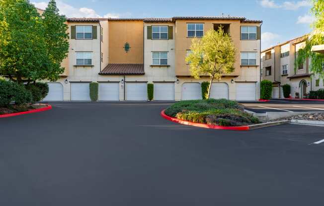 an empty parking lot in front of an apartment building