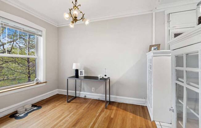 an empty room with white walls and a table in the corner at The Bryant at Oak Park I & II, Oak Park, IL