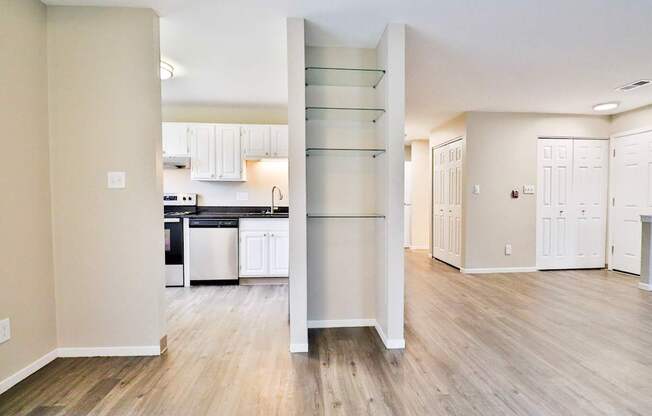 A kitchen with a white cabinetry and a white fridge.