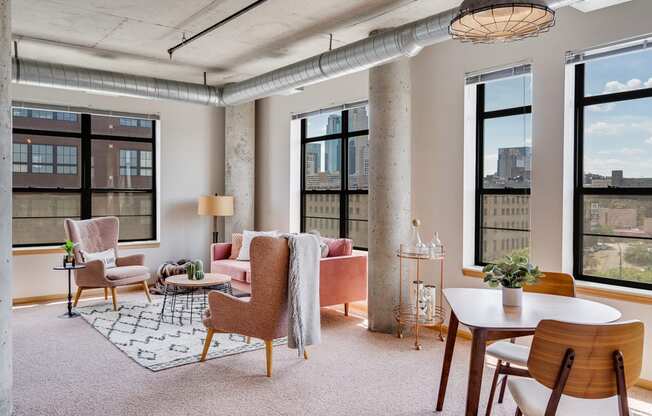 Living room with large windows and a variety of seating