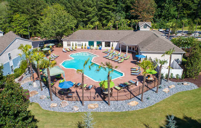 a aerial view of a pool with chairs and umbrellas