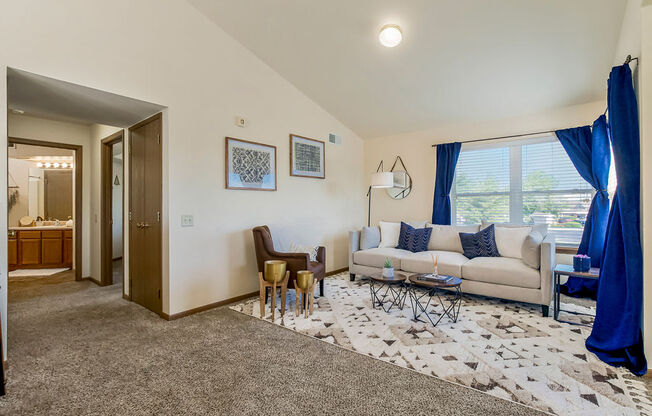 Open Living Room With Lots Of Natural Light & Vaulted Ceilings