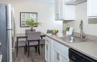 600 10th Ave Apartment Kitchen with Stainless Steal Appliances and White Cabinetry