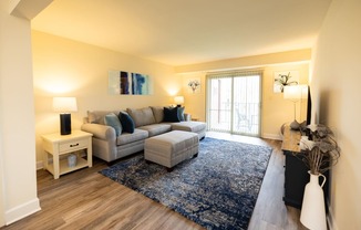 Living room with a couch at Rockdale Gardens Apartments*, Baltimore.