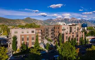 an aerial view of an apartment complex with mountains in the background