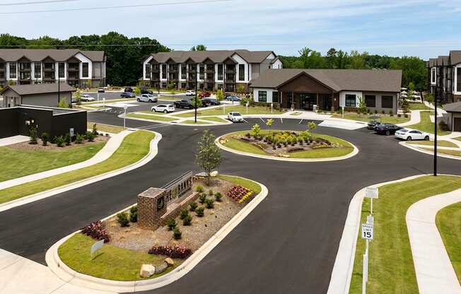 an aerial view of a street with houses and a parking lot