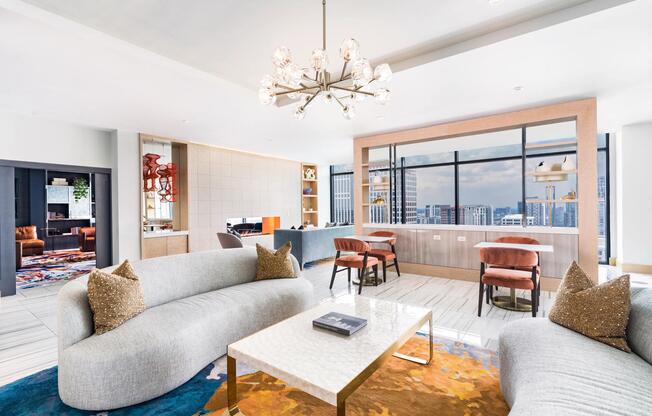 30th floor lounge with curved seating, conversational nooks, and floor-to-ceiling windows framing panoramic Atlanta views from above the city.