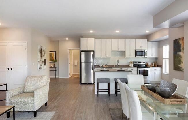 A modern kitchen with a dining table and chairs.