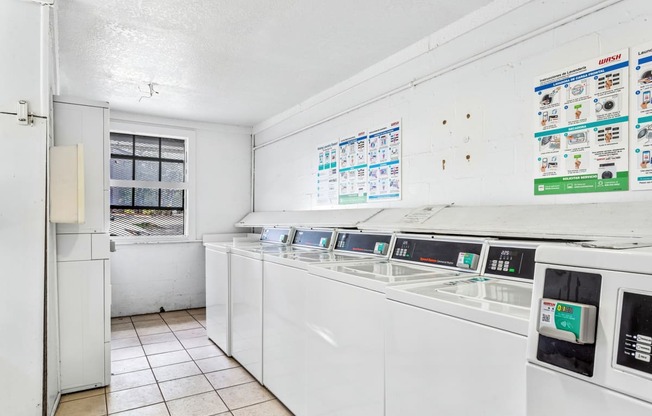 a kitchen with white appliances and a window