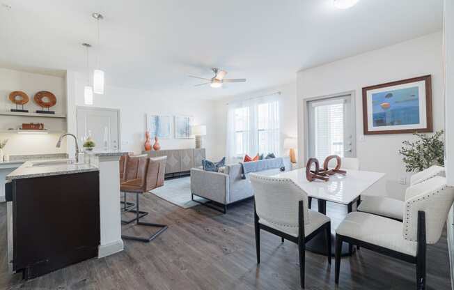 a living room with a dining room table and a kitchen