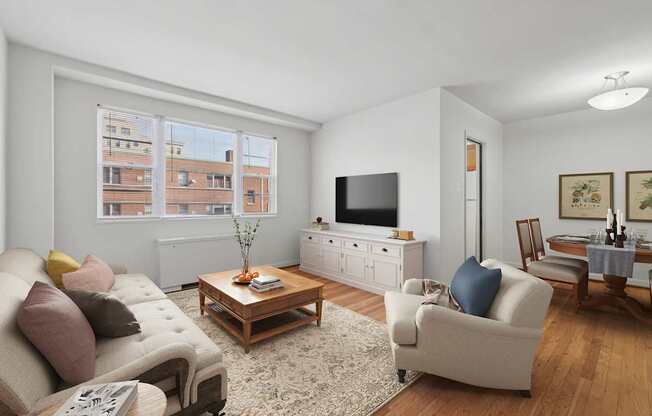 A living room with a couch, a coffee table, and a television.