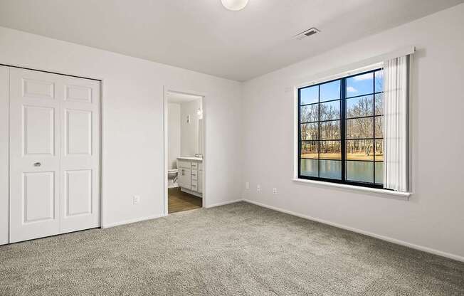 A bedroom with an attached bathroom and a closet at Tanglewood Apartments, Oak Creek, WI