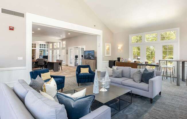a living room with couches and chairs and a table