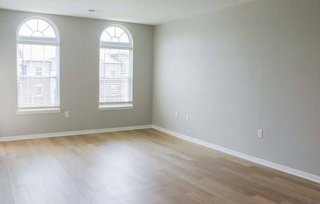 an empty room with three windows  at Alexandria of Carmel Apartments, Carmel, IN, 46032
