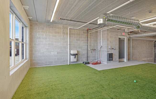 the yard is carpeted and has a soccer ball on the grass