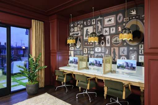 a room with red walls and a long table with green chairs at Fairfax, Grandview, OH