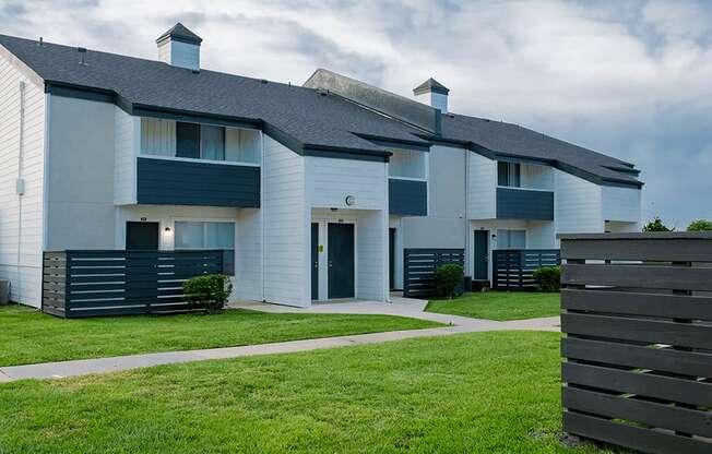 a picture of a white and blue apartment complex