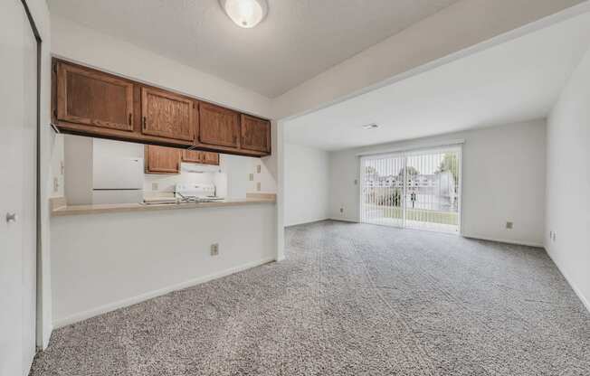 A room with a grey carpet and white walls.