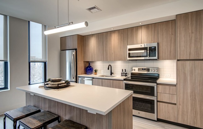 a kitchen with wood cabinets and white countertops