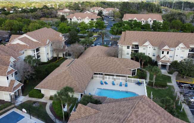 a aerial view of a swimming pool in a neighborhood of houses