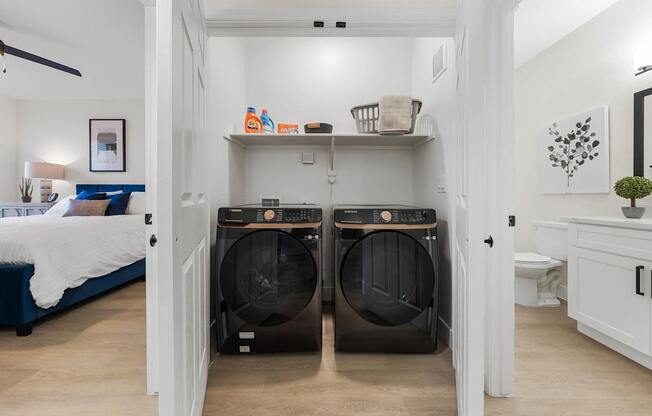 A laundry room with two front-loading washing machines.