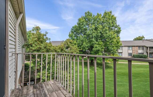 the view from the deck of a home with a yard and a tree at Edge At Farmington Hills - Farmington Hills, MI, Michigan, 48334