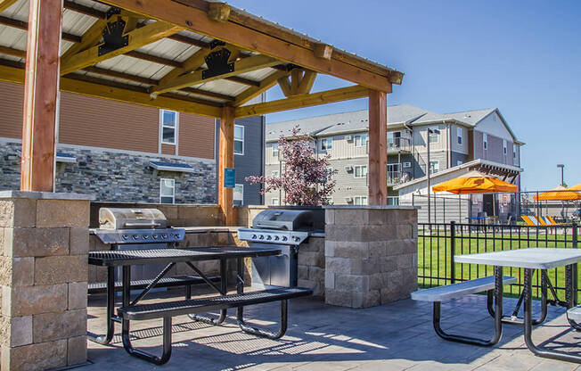 a patio with a grill and picnic table at the villas at falling waters in west om