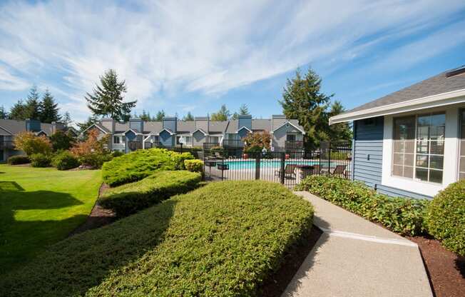 Apartments in Silverdale for Rent-Ridgetop Apartments Gated Swimming Pool Surrounded by Lush Landscape
